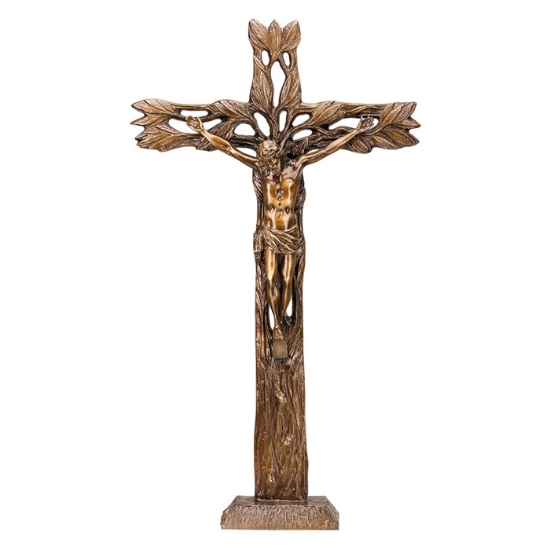 Image sur Crucifix en bronze sur une croix faite sur un tronc orné de feuilles